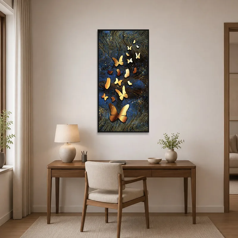 Golden butterflies art energizing a sleek desk area with a laptop and plant.
