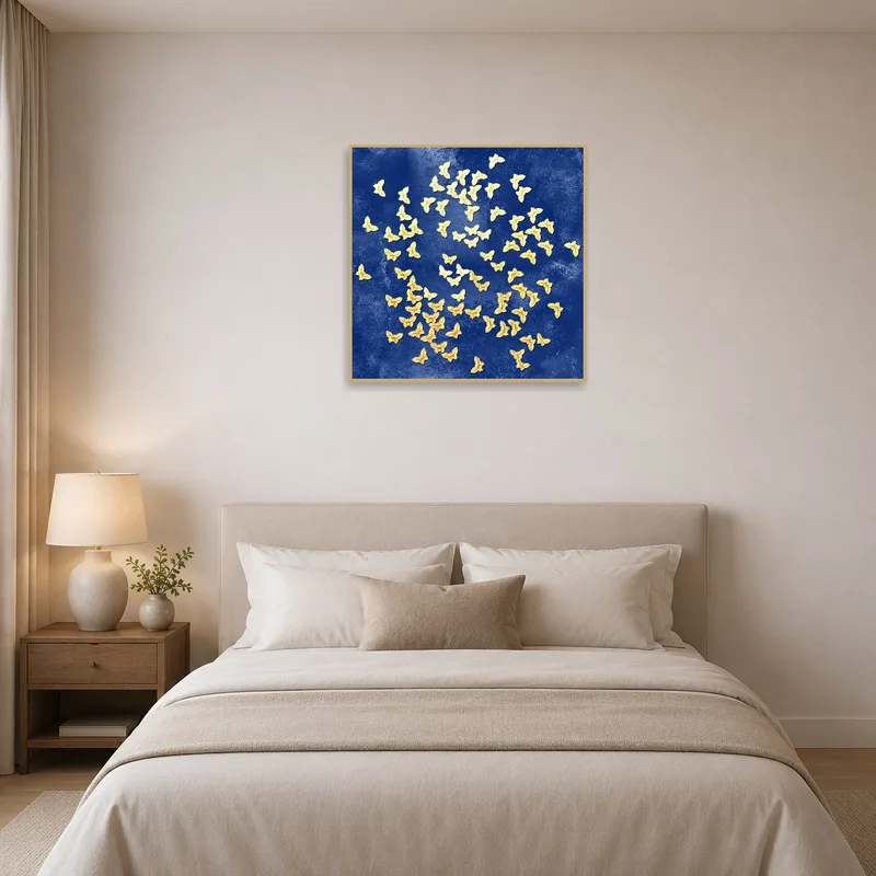 Deep blue canvas with golden butterflies adds elegance to a bedroom decor.