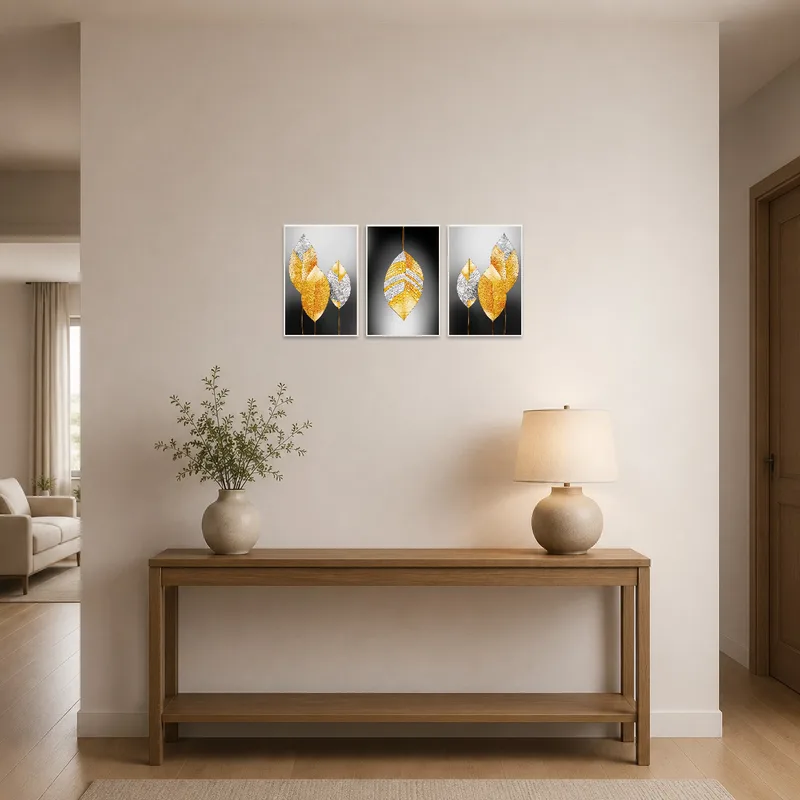 A golden leaf triptych set greets you in the entrance hall on a neutral wall.