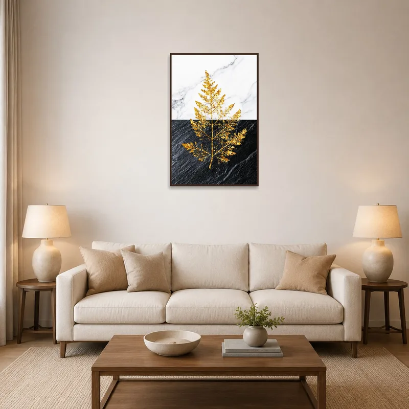 Golden leaf art print on marble and slate above a modern living room sofa.