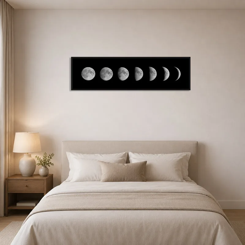 Serene bedroom with a lunar phases print above the bed.