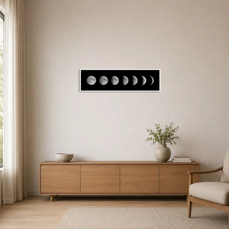 Lunar phases art print on a stark white wall in a minimalist space.