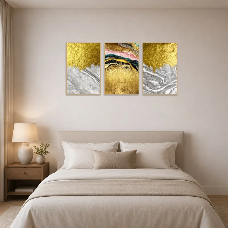 Abstract triptych adorns a bedroom wall, complementing luxurious bedding.