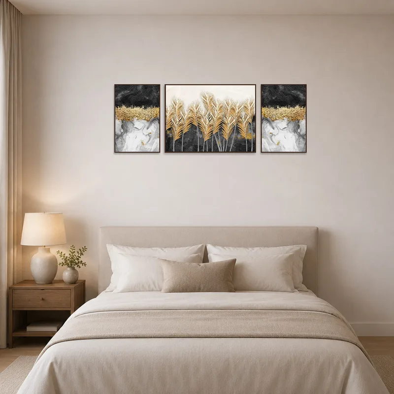Elegant gold and black abstract triptych set above a bedroom headboard.