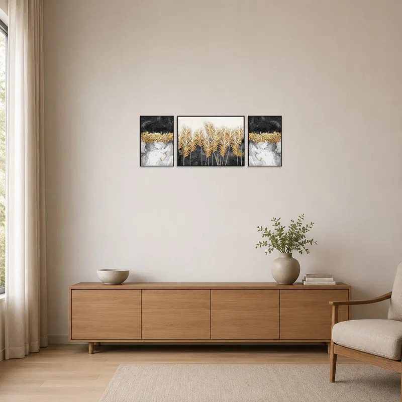 Sleek gold and black abstract triptych in a minimalist setting.