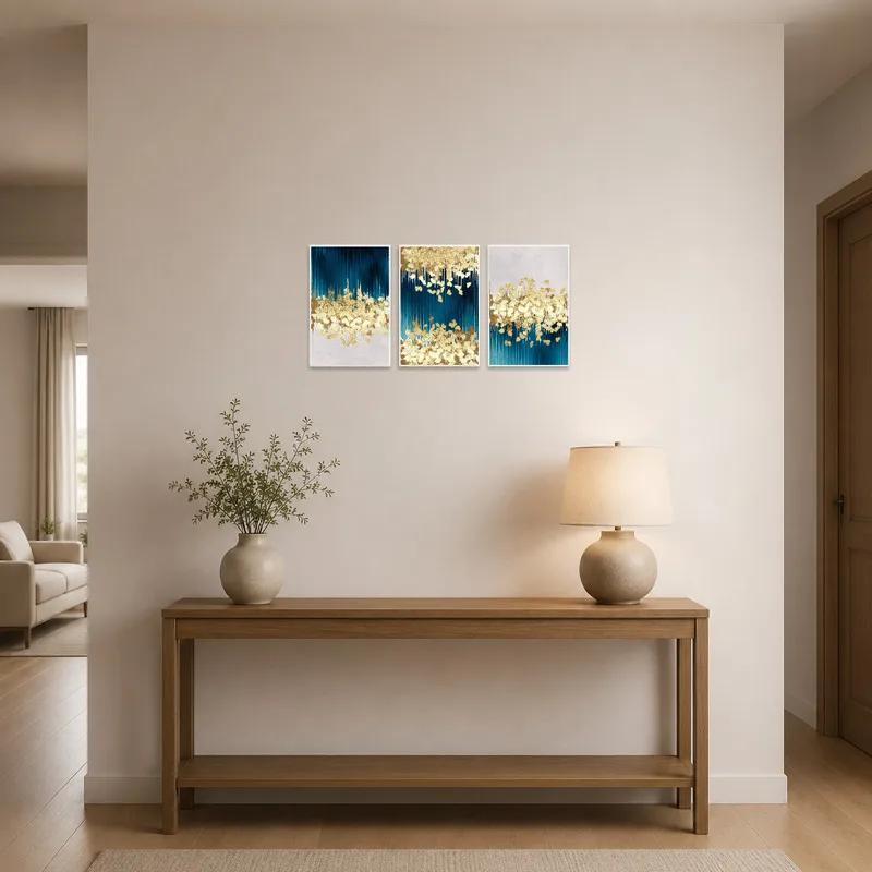 Art triptych featuring blue and gold hues displayed in an elegant entrance hall.