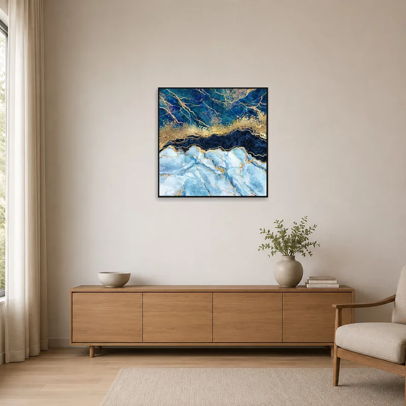 Minimalist room with abstract blue and gold marble art print on stark white wall.
