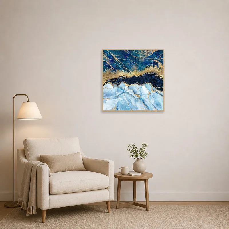 Reading corner featuring luxurious blue and gold marble art print above a cozy chair.