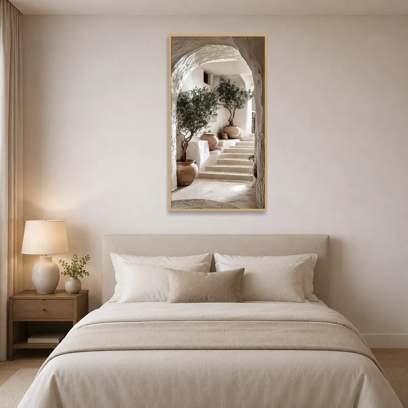 Mediterranean archway print hung on a bedroom wall near the bed.
