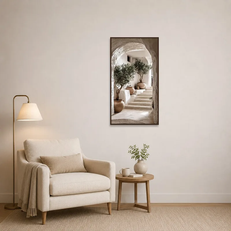 Print of archway adding charm to a reading corner with an armchair.