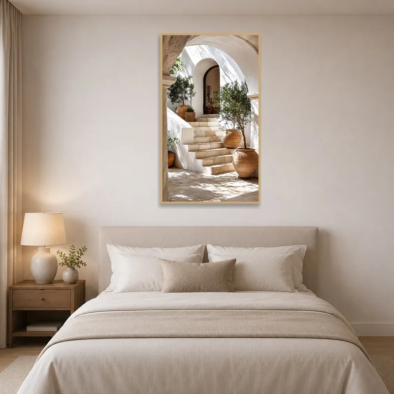 Bedroom accentuated by an art print of a Mediterranean courtyard with olive trees.