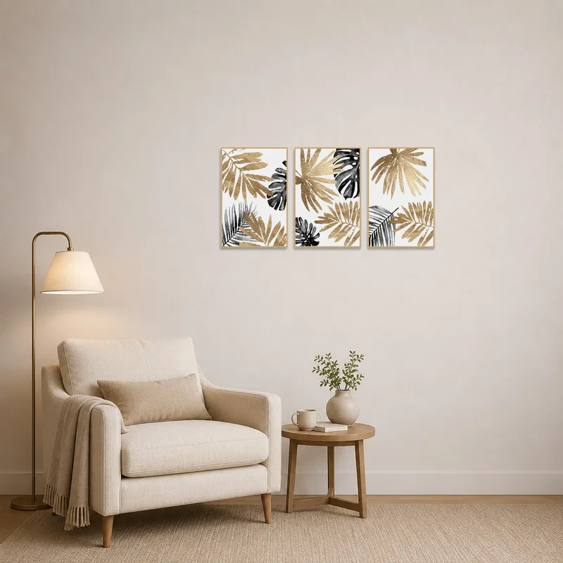 Modern botanical leaf triptych in gold and charcoal adds elegance to a cozy reading corner.