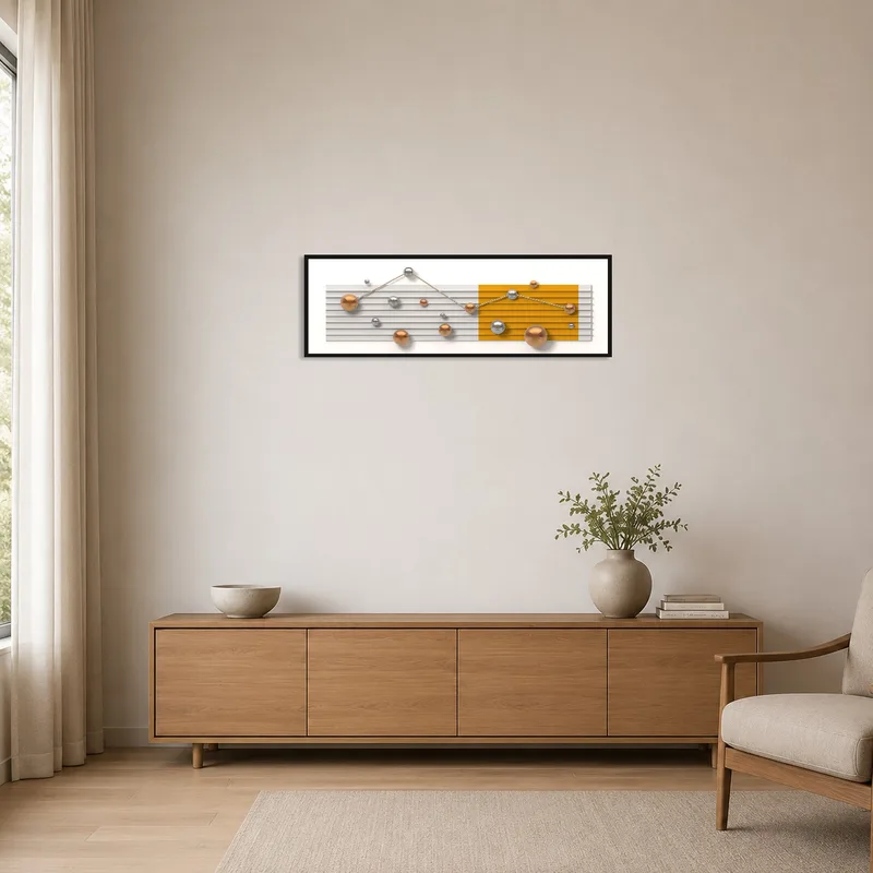 Modern geometric spheres art hanging on a white wall in a minimalist room with sparse furnishings.