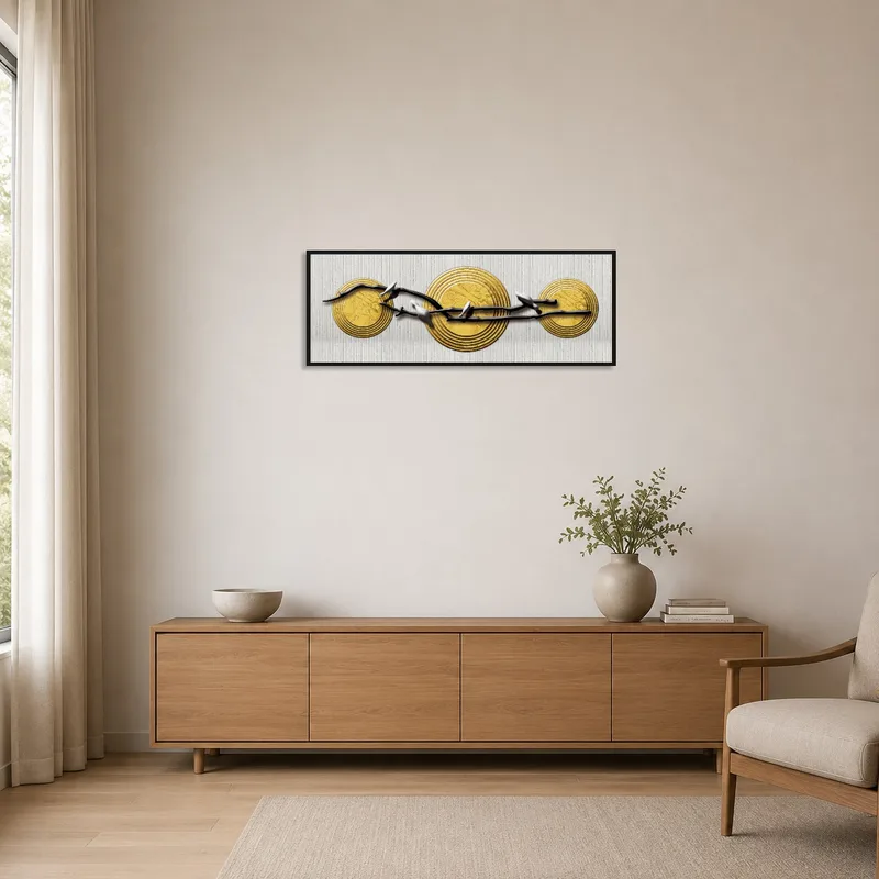 Minimalist room with golden disc and branch art on a clean, bright wall.