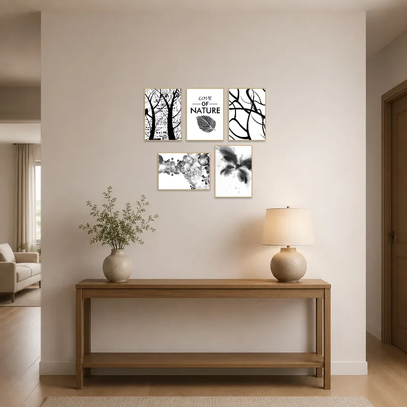 Abstract nature prints in monochrome greet visitors in an entrance hall by a console table.