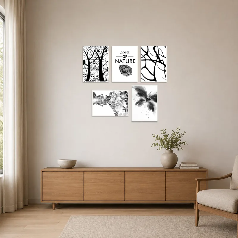 Set of monochrome abstract nature prints on a clean, minimalist wall beside simple furnishings.