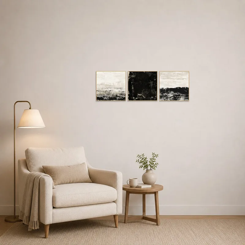 Reading corner adorned with a monochrome abstract triptych in textured layers.