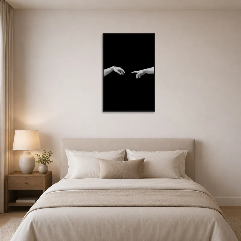 Monochrome hands art print hangs above a stylish bed in a calm bedroom.