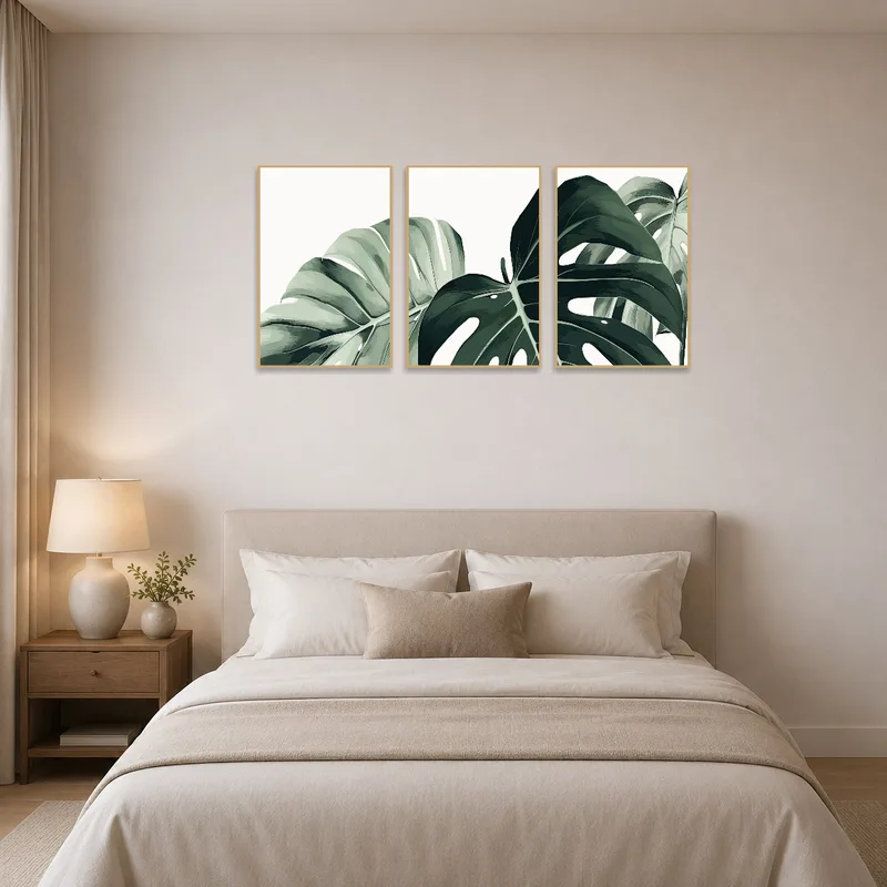 Monstera leaf art set enhancing a relaxed bedroom ambiance.