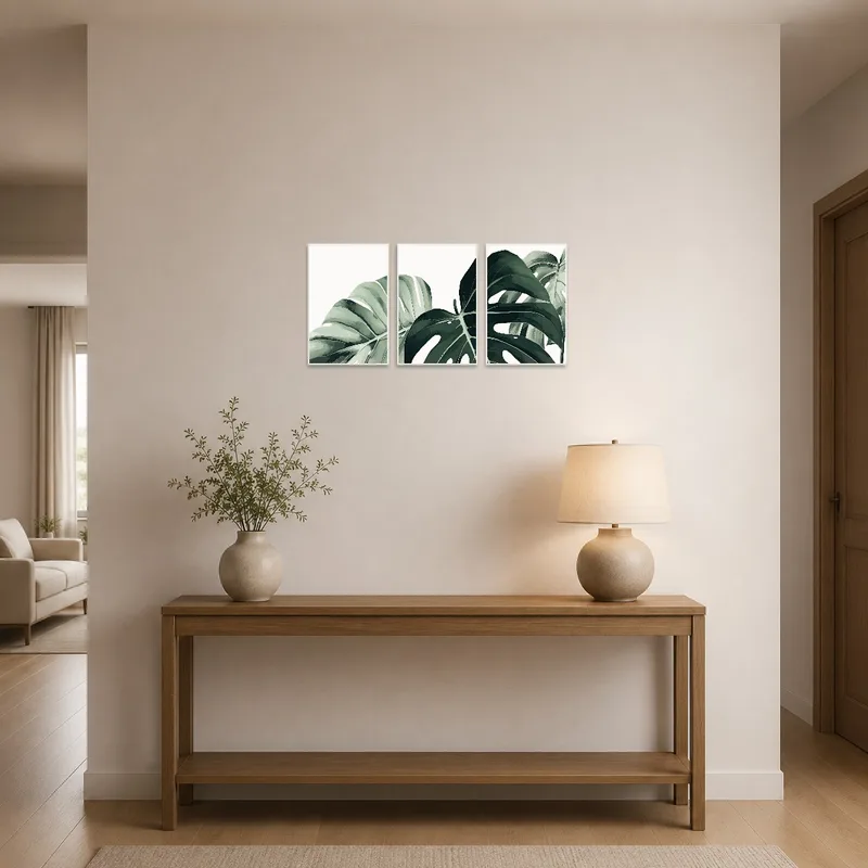 Monstera leaf art set greeting visitors in a bright entrance hall.