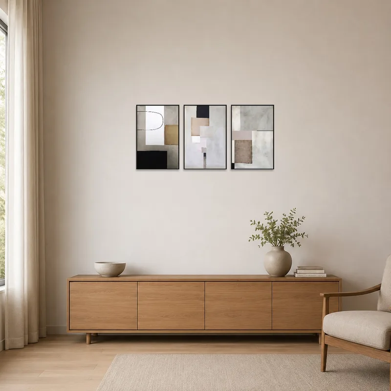 Geometric abstract triptych on a white wall in a minimalist space.