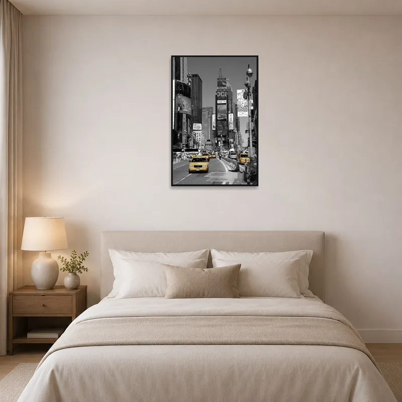 New York taxis artwork hanging above a bed with neutral bedding.
