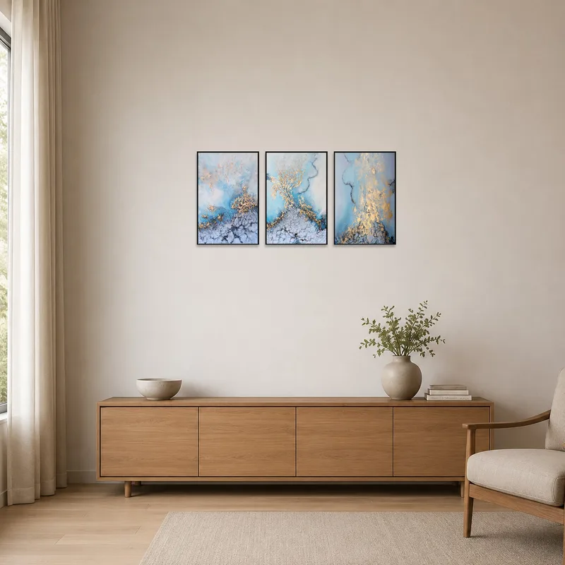 Abstract triptych enhances a minimalist room with serene oceanic hues.