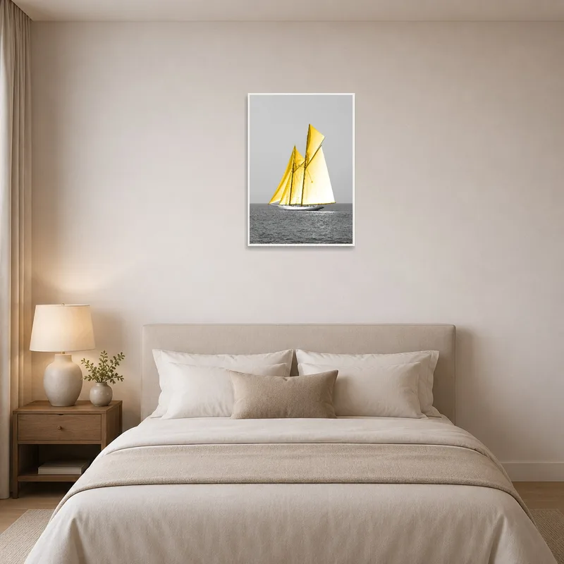 Art of a sailboat with yellow sails adds warmth above a bed with soft linens.
