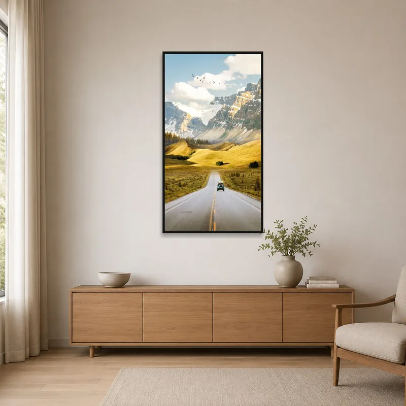 A sleek, minimal setting showcasing art of a vintage car driving through mountainous scenery.