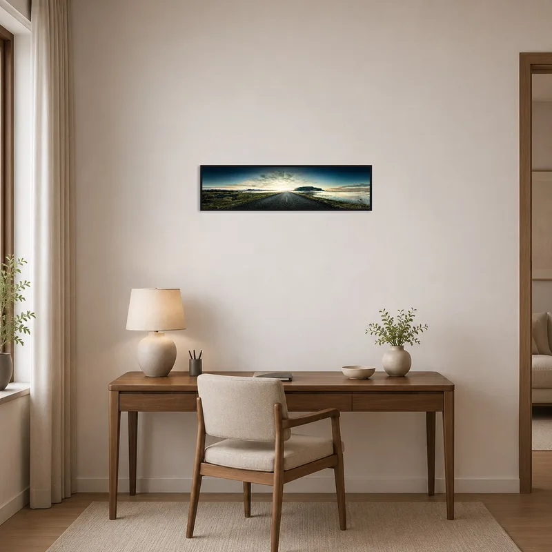 Panoramic scenic road print inspires travels, hanging behind the desk in the home office space.