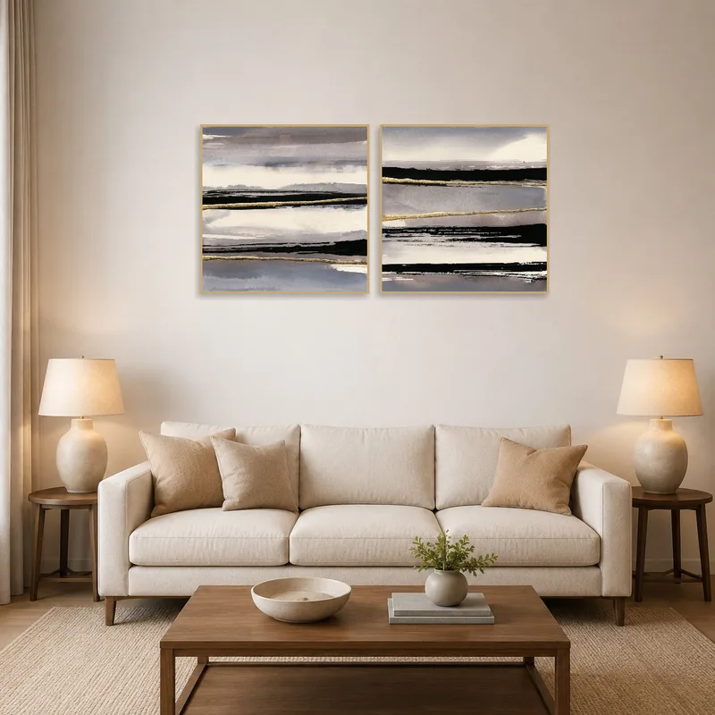 Monochrome abstract landscape duo over the sofa in a modern living room.