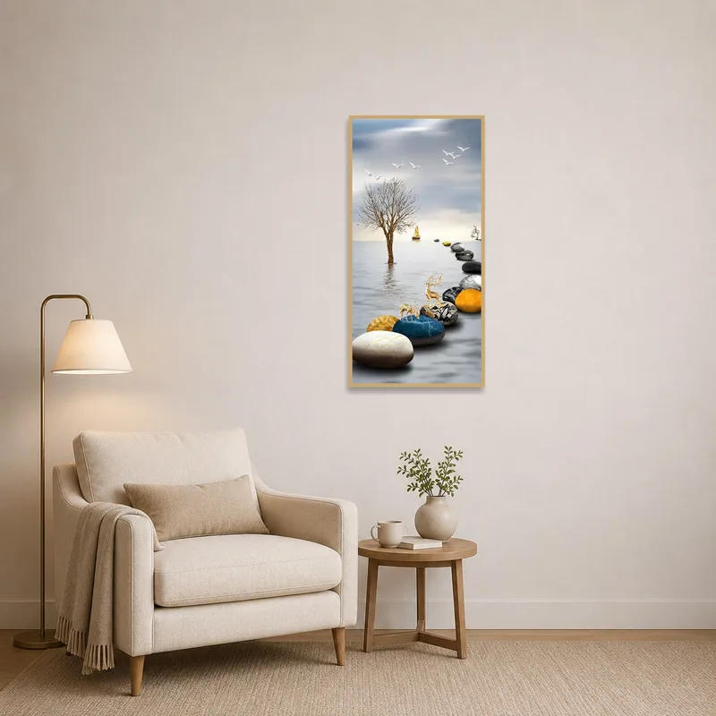 Next to a comfortable chair, the artwork of stones and a boat inspires a calm reading corner.