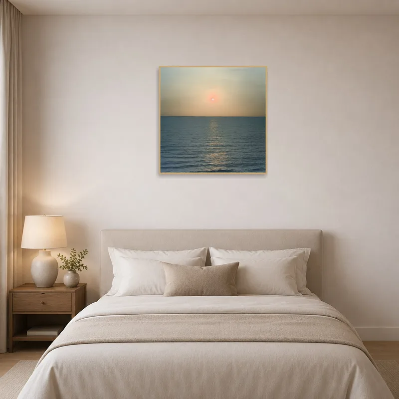Bedroom with ocean sunset art above the bed's headboard.