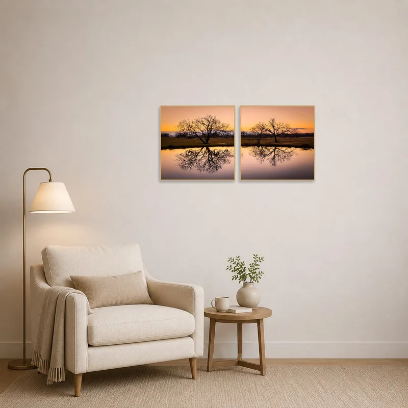 Soothing sunset art beside a comfy chair in a reading corner.