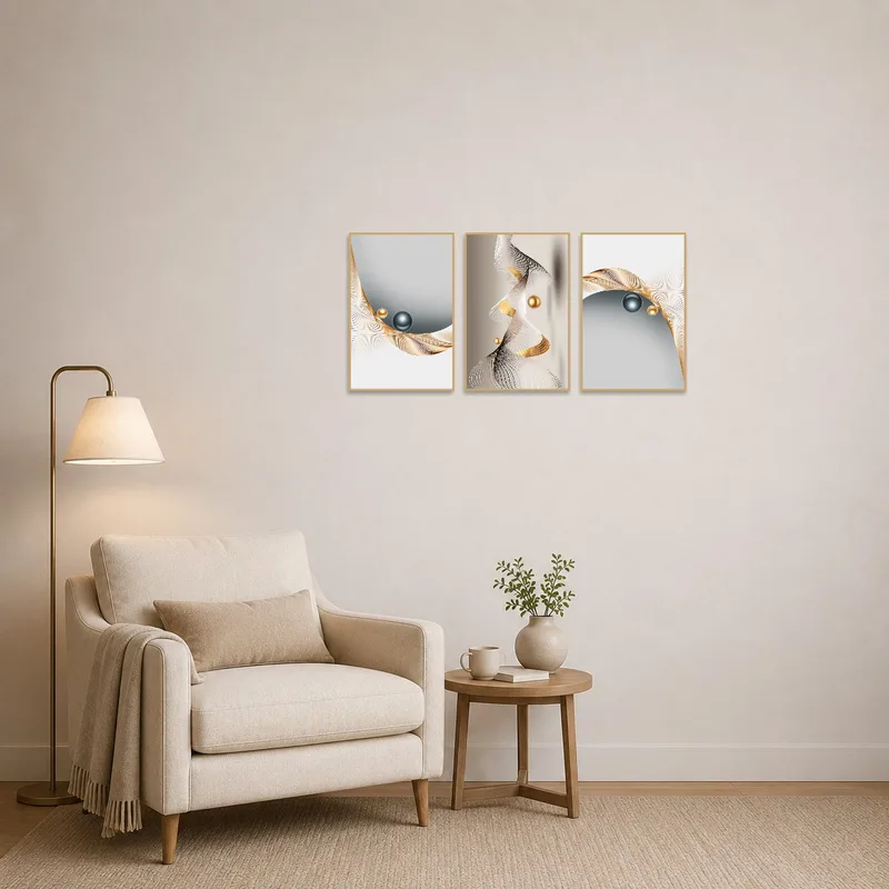 Abstract triptych with gold and silver hues displayed in a cozy reading corner.