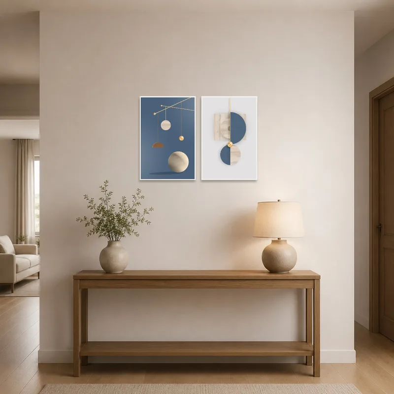 The prints hang beside a sleek console table and mirror in an entrance hall.