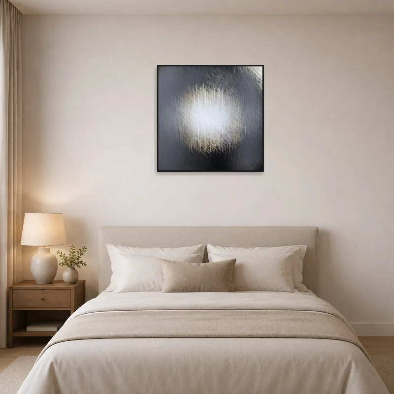 A textural abstract canvas with metallic hues providing a soothing accent in a serene bedroom.