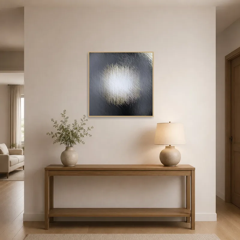A textural abstract canvas with metallic hues welcoming guests in an entrance hall.