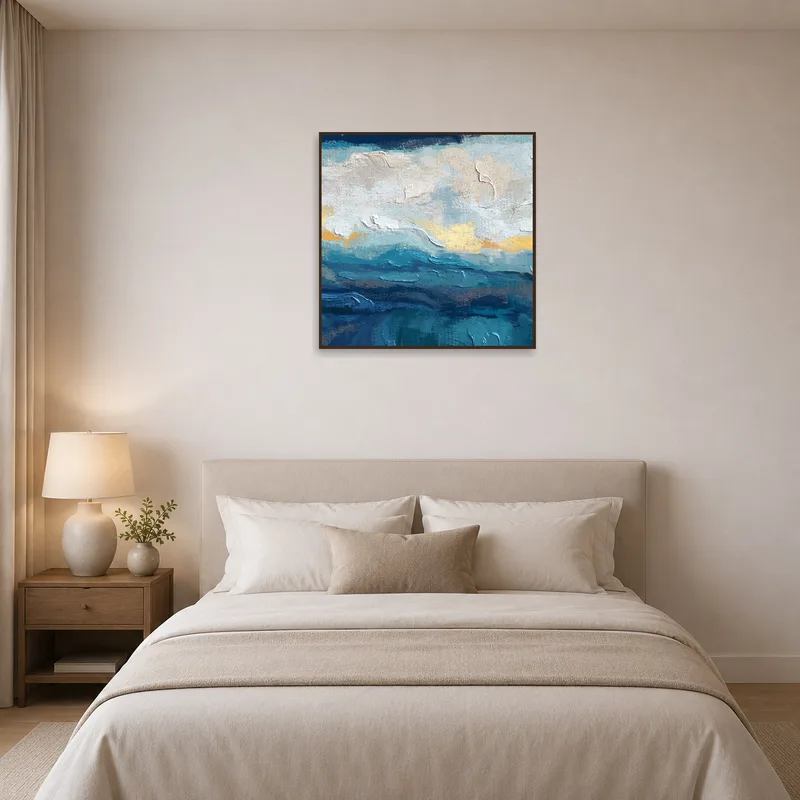 Ocean blue abstract art adds tranquility to a bedroom with soft lighting.