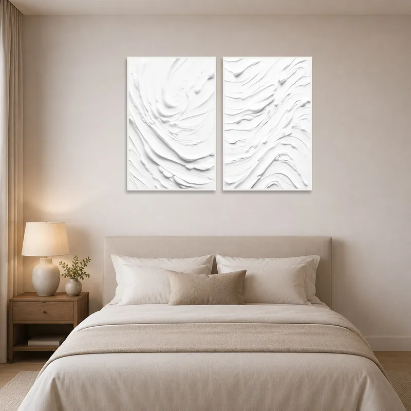 Abstract white set complements soft tones in a serene bedroom.