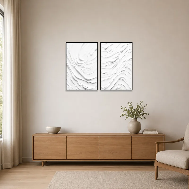 Sleek white abstract canvases on plain walls in a minimalist setting.