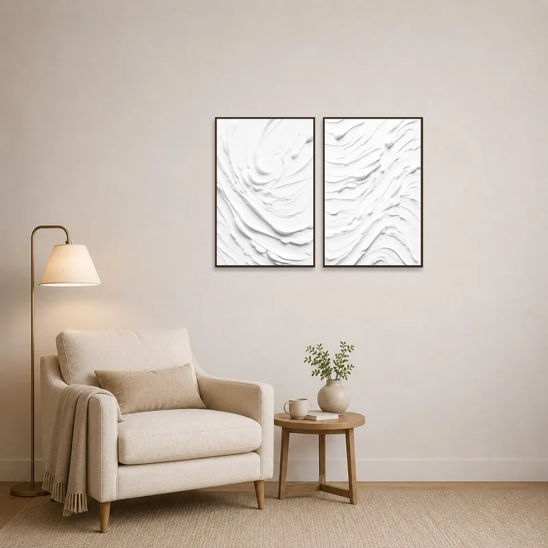 Textured white canvases beside a comfy chair in a reading-corner.