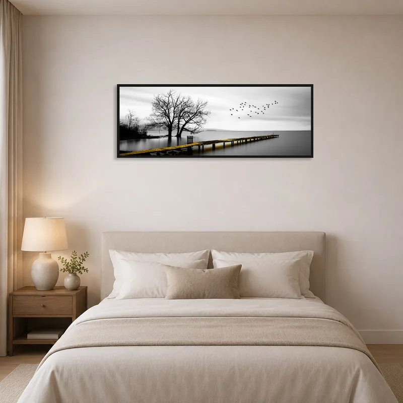 Bedroom with calming art of a pier on a tranquil lake.