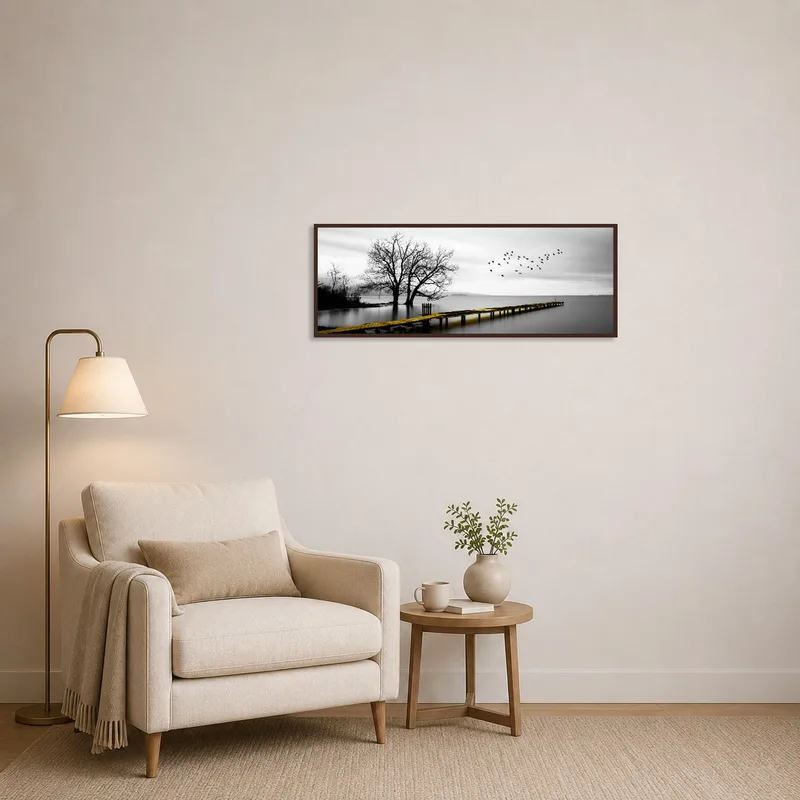 Reading corner accented with a tranquil lake and tree picture.