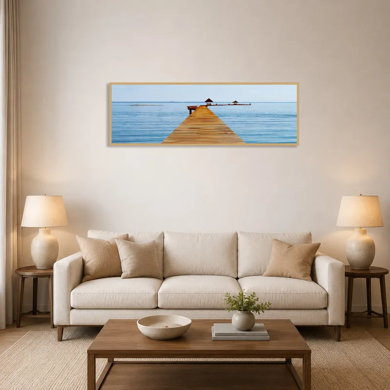 The serene pier artwork adorns a cozy living room wall.