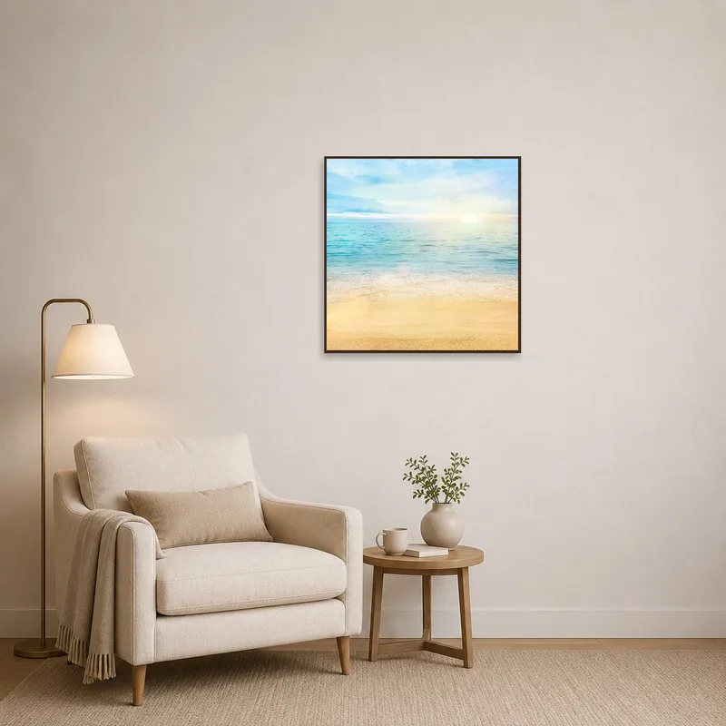 Sunrise seascape art next to a comfy chair in a reading corner.