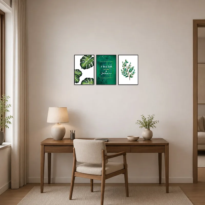 Home office with tropical botanical wall art characterized by lush green foliage.
