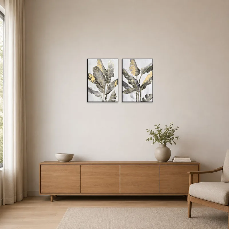 Minimalist room with a touch of sophistication from the tropical leaf art in gold and gray.