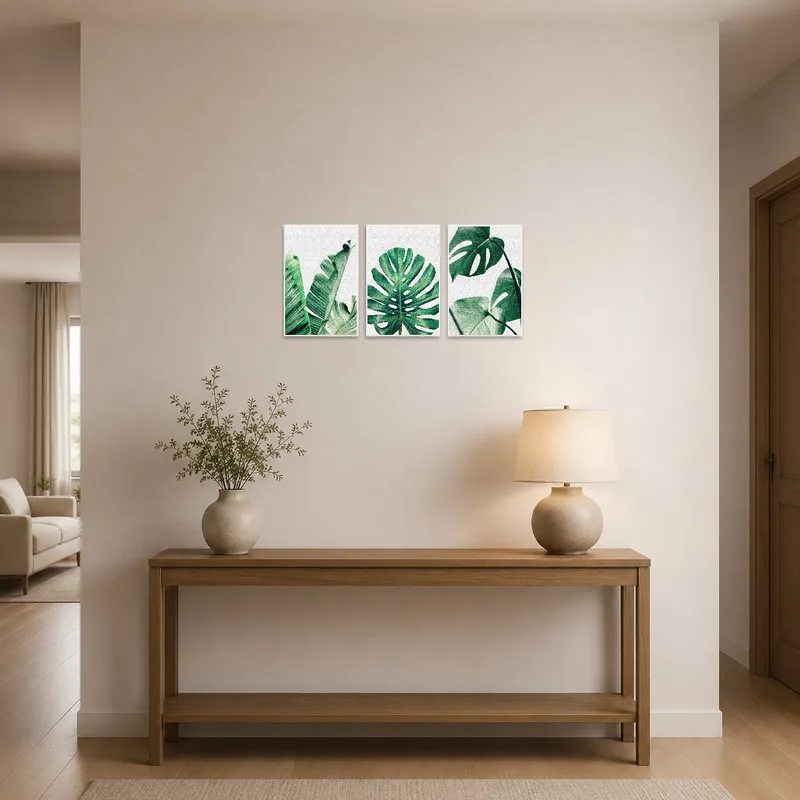 Triptych of tropical green leaf art enhancing an entrance-hall with natural tones.