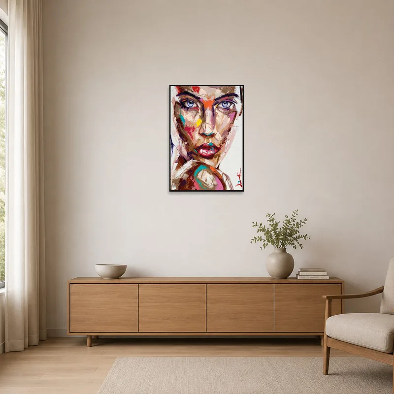 Abstract portrait with vivid colors adding a bold splash to a minimalist space with sparse furnishings.
